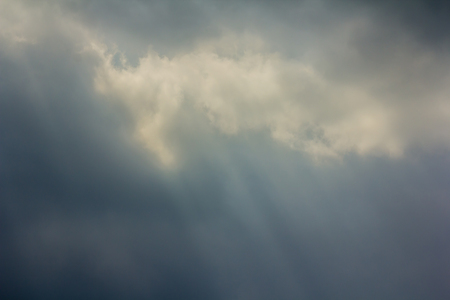 Rays of light shining through dark clouds