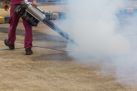 Worker fogging mosquito to prevent of dengue fever Medical concept.