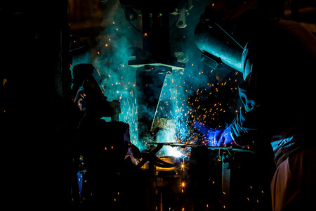Welder is welding automotive part in factoryの写真素材