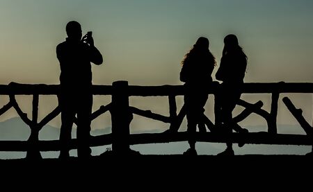 Silhouette of people having fun at sunset timeの写真素材