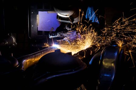 Workers are grooving with carbon welding wires With sparksの写真素材