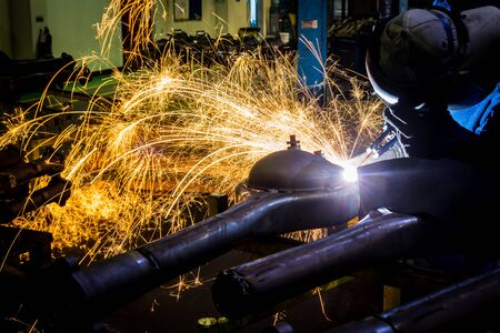 Workers are grooving with carbon welding wires With sparksの写真素材