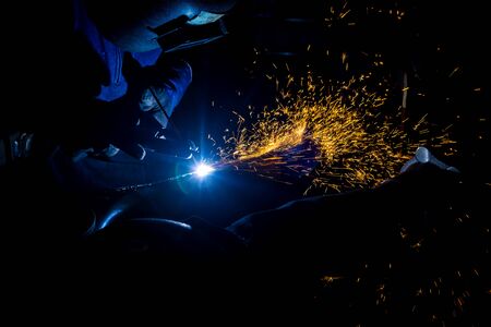Workers are grooving with carbon welding wires With sparksの写真素材