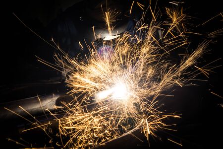 Workers are grooving with carbon welding wires With sparks