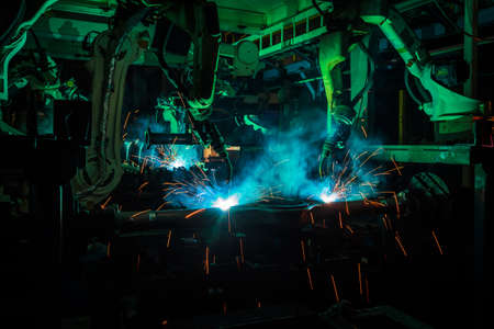 Industrial welding robots represent the movement in the automotive parts industry.