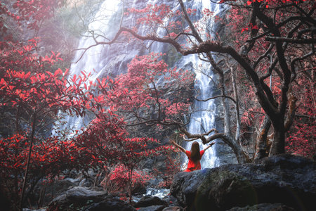 Klong Lan Waterfall is a natural tourist attraction in Thailand. There was a young lady in red,...