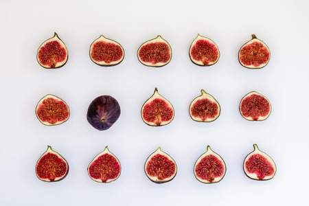 Pattern of sliced ripe figs in the form of rectangle isolated on white background. Fruit illustration. Food photo. Flat lay, Top view.の写真素材