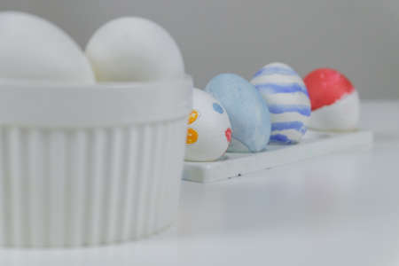 A table with white and colored eggs, prepared for decoration for Easter.の写真素材
