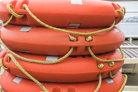 Stack lifebuoy orange lying on the deck of the ferry, boat, shipの写真素材