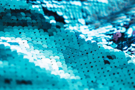 AI aqua blue trendy color of year 2021 sequin fabric texture. Shiny sparkling background. Clothing...