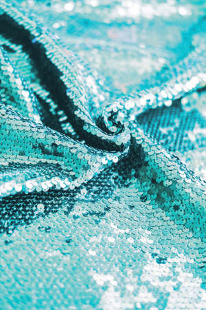 AI aqua blue trendy color of year 2021 sequin fabric texture. Shiny sparkling background. Clothing...