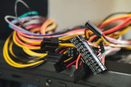 Young man repairs a computer system unit, changes parts, video card and hard drive, sets new...