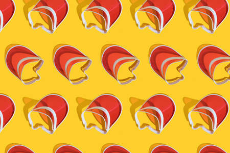 Bright red sports sun cap on a yellow background with a hard shadow. Creative texture food banner....