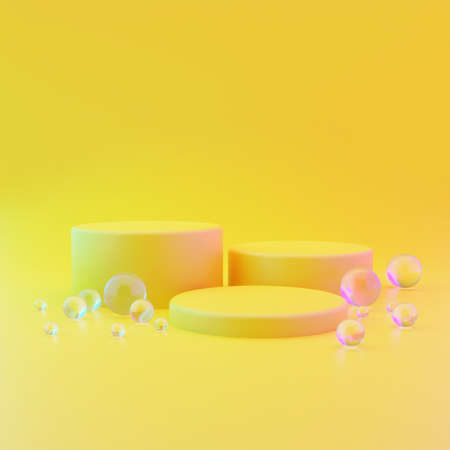 Three cylindrical geometric mockups of the podium on yellow illuminating background with round glass balls on the floor. Minimalistic trendy style for cosmetics advertising. 3d render illustration.の写真素材