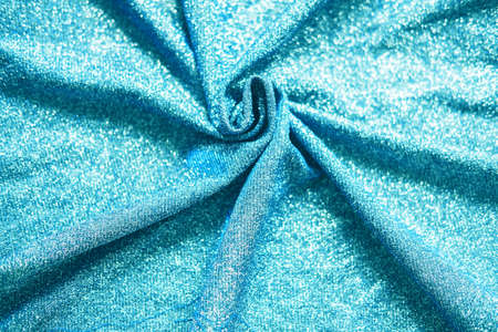 Colored blue shiny fabric texture with folds. Surface background colors of the year 2021の写真素材