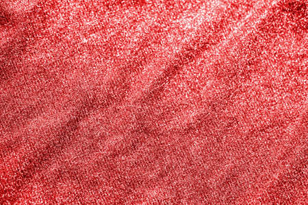 Colored red shiny fabric texture with folds. Surface background colors of the year 2021の写真素材