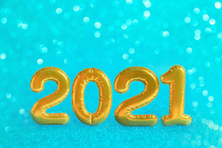 Christmas festive background with golden numbers 2021. Abstract glitter blurred background shiny blue ai aqua. Bright sparkling wallpaper with bokeh textureの写真素材