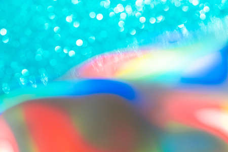 Abstract mixed holographic blue ai aqua blurred glitter shiny background. Liquid neon rainbow foil unicorn style. Bright sparkling bokeh style. Festive Christmas holiday iridescent futuristic textureの写真素材