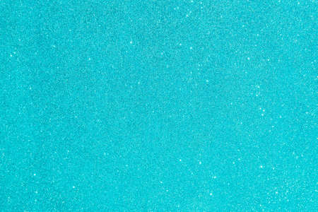 Abstract glitter blurred shiny blue aqua background. Bright sparkling bokeh wallpaper style. Festive Christmas holiday futuristic texture.の写真素材