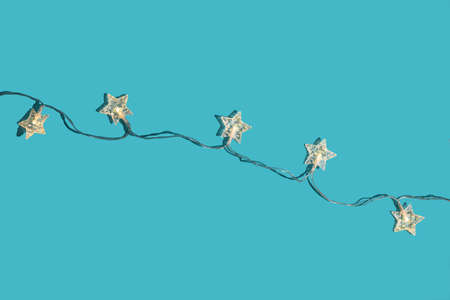 Christmas minimal festive background with star garland. Abstract christmas background shiny blue ai aqua. Flat lay. Top view.の写真素材