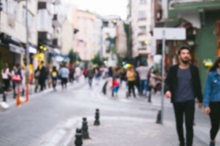 Bright defocused blurred background with unrecognizable people on the sity street. Abstract image of crowd of people in public place.の写真素材