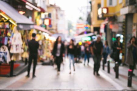 Bright defocused blurred background with unrecognizable people on the sity street. Abstract image of crowd of people in public place.の写真素材