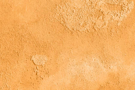 Concrete orange colorful wall surface texture. Abstract grunge bright marigold color background with aging effect. Copyspace. Trendy color of the year 2021.の写真素材
