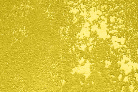 Concrete Yellow colorful wall surface texture. Abstract grunge bright illuminating color background with aging effect. Copyspace. Trendy color of the year 2021.の写真素材
