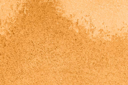 Concrete orange colorful wall surface texture. Abstract grunge bright marigold color background with aging effect. Copyspace. Trendy color of the year 2021.の写真素材