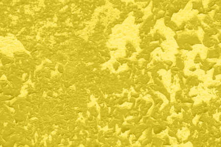 Concrete Yellow colorful wall surface texture. Abstract grunge bright illuminating color background with aging effect. Copyspace. Trendy color of the year 2021.の写真素材