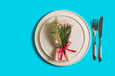 Served table with empty plate and cutlery for celebration of Christmas and New Year. On plate is...