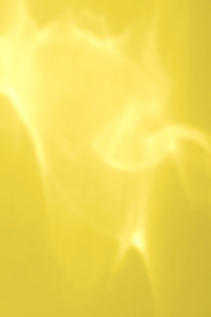 Abstract glass reflection yellow background. Neon illuminating foil in unicorn style. Marble futuristic texture. Trendy color style 90s.の写真素材