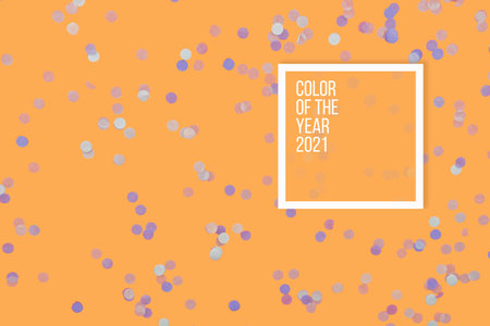 Festive Christmas and New Year background with confetti on bright orange marigold background. Top View. Flat lay. Concept of preparation for holidays. Trendy color 2021.の写真素材
