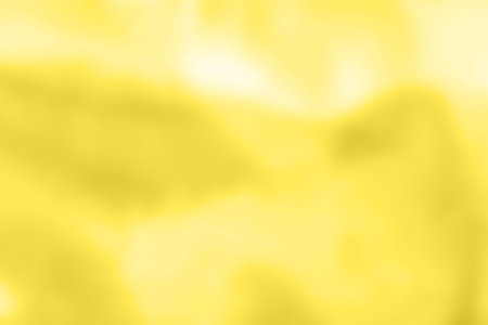 Abstract holographic yellow background. Liquid neon illuminating foil in unicorn style. Marble iridescent futuristic texture. Trend style 90s.の写真素材