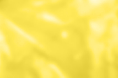 Abstract holographic yellow background. Liquid neon illuminating foil in unicorn style. Marble iridescent futuristic texture. Trend style 90s.の写真素材