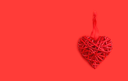 Red wicker heart symbol lies on the background to Valentines Day. Top view. Flat lay. Greeting card,...