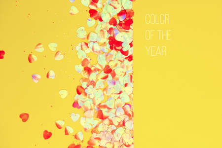 Festive Christmas and New Year background with confetti on bright yellow background. Top View. Flat lay. Concept of preparation for holidays.の写真素材