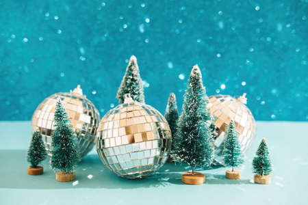 Christmas festive background with christmas toy trees and disco balls. Abstract glitter blurred background shiny blue ai aqua. Bright sparkling wallpaper with bokeh texture.の写真素材