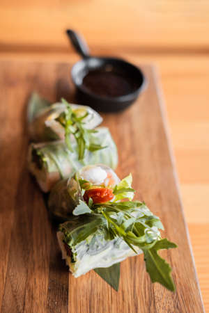 Spring rolls with shrimp, wooden chopsticks and soy sauce. Asian cuisine.の写真素材