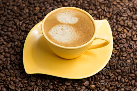 Roasted coffee beans evenly and a Cup of coffee