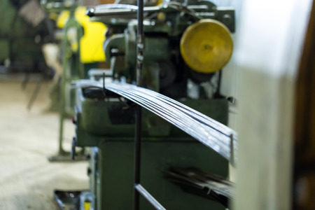 Gauged steel metal as the raw material for the turning parts on Cam turning machines. A bundle of bars lies at the machine shop.の写真素材