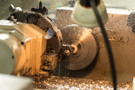 Production of parts on a metal lathe.Rotating parts, flying coolant spray