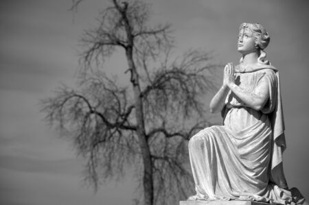 Black and White image of praying statue in Riverside Cemetery.の写真素材