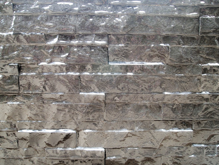 pattern gray color stone wall background , modern style design decorative real stone wall surfaceの写真素材