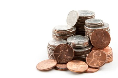 Stack of pennies, nickles, dimes, and quarters isolated on right side of frame.