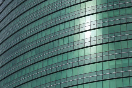 transparent glass windows of office building with reflectionsの写真素材