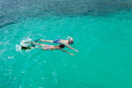 skindiving in the sea with goggles and a snorkelの写真素材