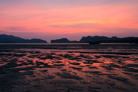 Beautiful golden sunset in the sea with saturated sky and clouds, in Thailandの写真素材