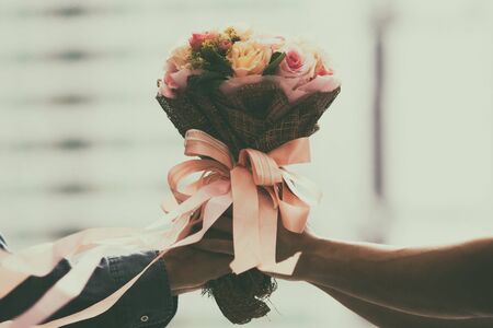 retro wedding bouquet with the flower in hands of the bride