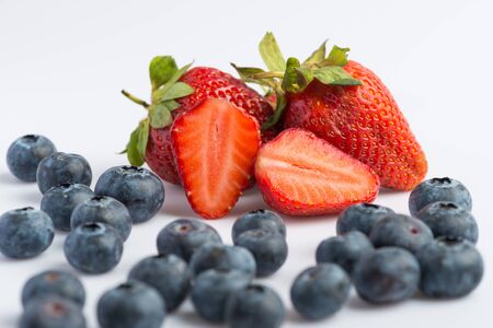 Fresh strawberries and blueberries on white backgroundの写真素材